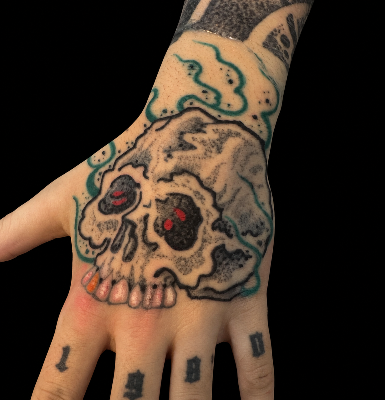 Skull hand tattoo on a solid black background