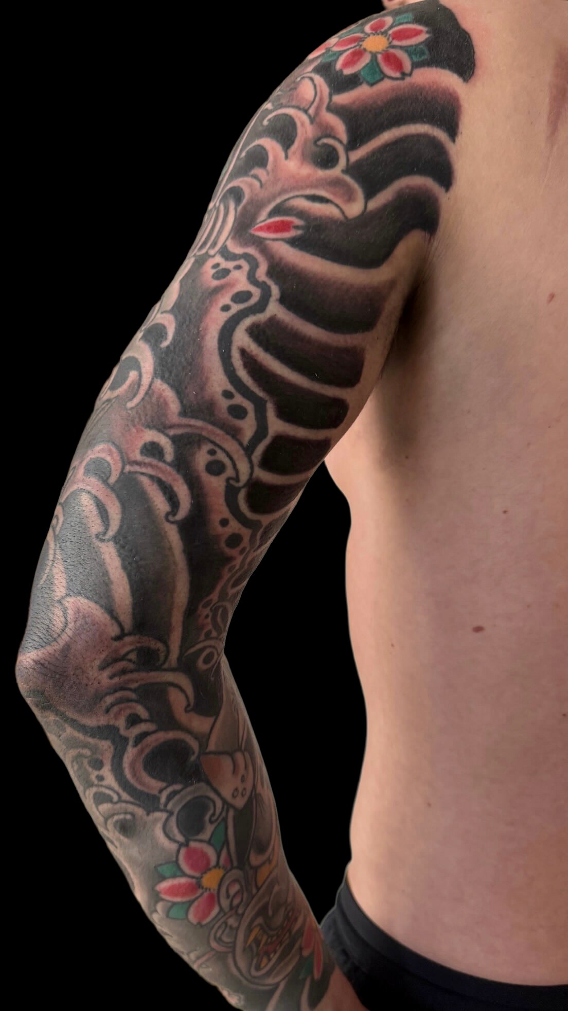 Black and grey Japanese sleeve with red accents