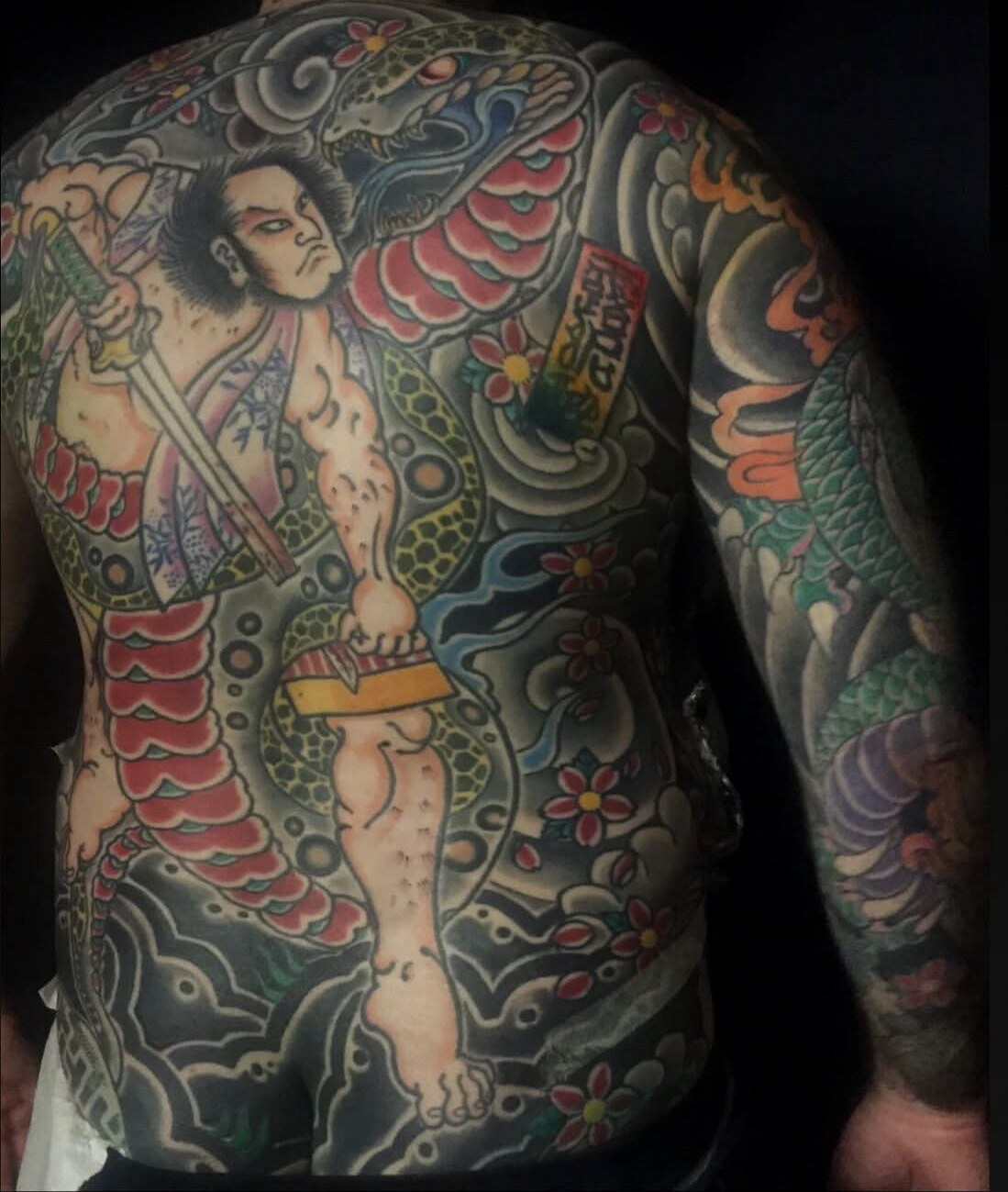 Japanese full torso and sleeve tattoo featuring a warrior and serpent