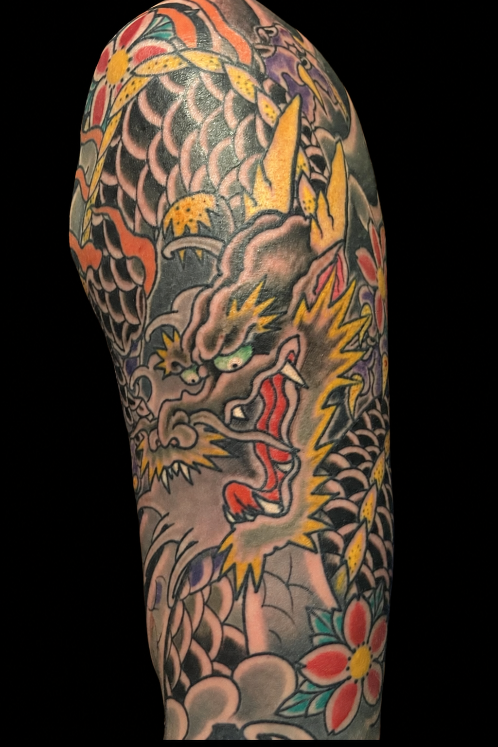 Japanese dragon and cherry blossom sleeve tattoo